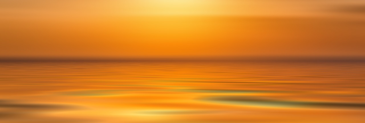 orange coloured calm water with the horizon in the back ground.